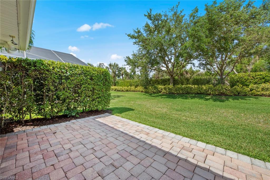 9046 Astonia Way Estero, FL 33967 - Photo 36 of 47 a view of a garden with a pathway