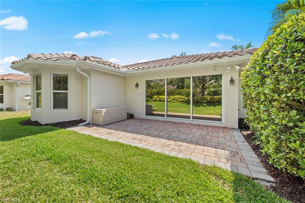 9046 Astonia Way Estero, FL 33967 - Photo 38 of 47 a view of a house with a porch and a yard