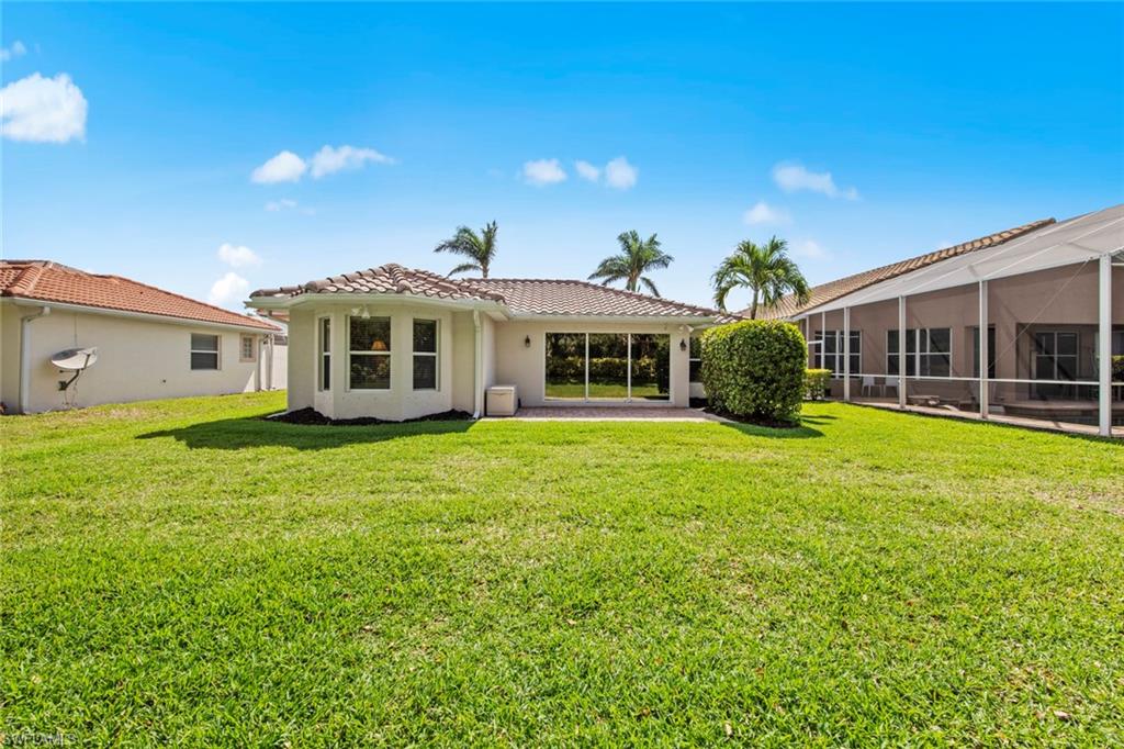 9046 Astonia Way Estero, FL 33967 - Photo 39 of 47 a view of a house with a backyard
