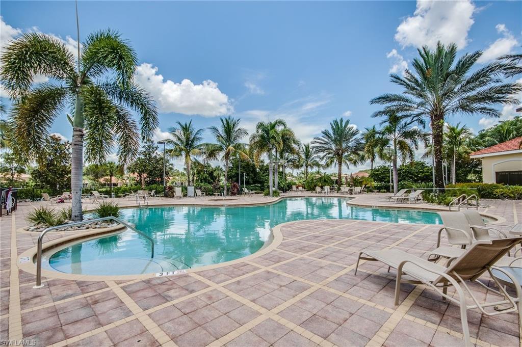 9046 Astonia Way Estero, FL 33967 - Photo 42 of 47 a view of a swimming pool with a patio and a garden