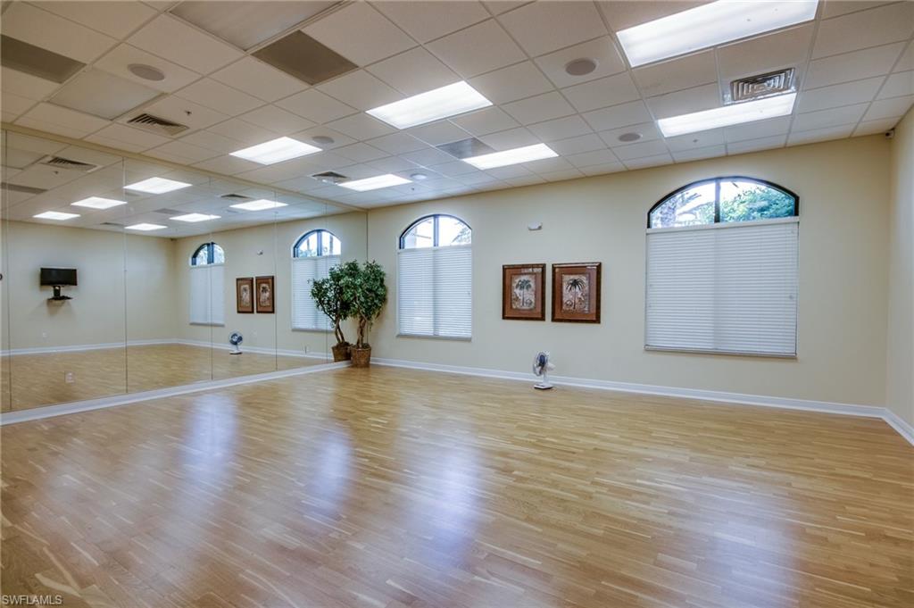9046 Astonia Way Estero, FL 33967 - Photo 46 of 47 a view of an empty room with wooden floor and a potted plant