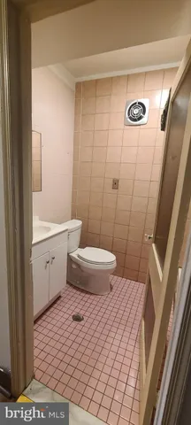 an empty room with a ceiling fan and windows