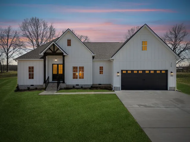 a front view of a house with a yard and garage