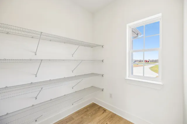 a view of a kitchen with white cabinets