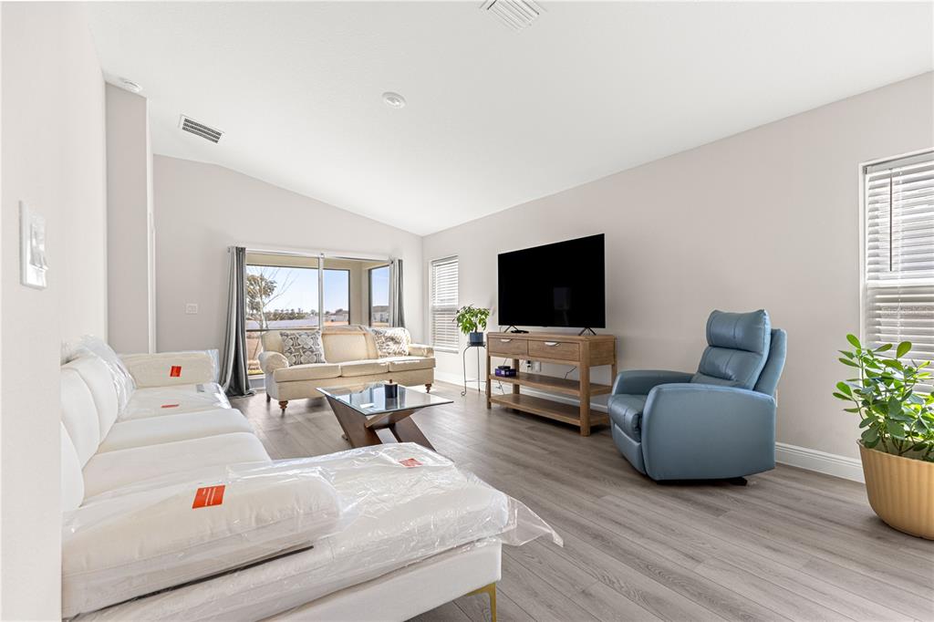 9611 Southwest 62nd Court Ocala, FL 34476 - Photo 11 of 41 a living room with furniture and a flat screen tv