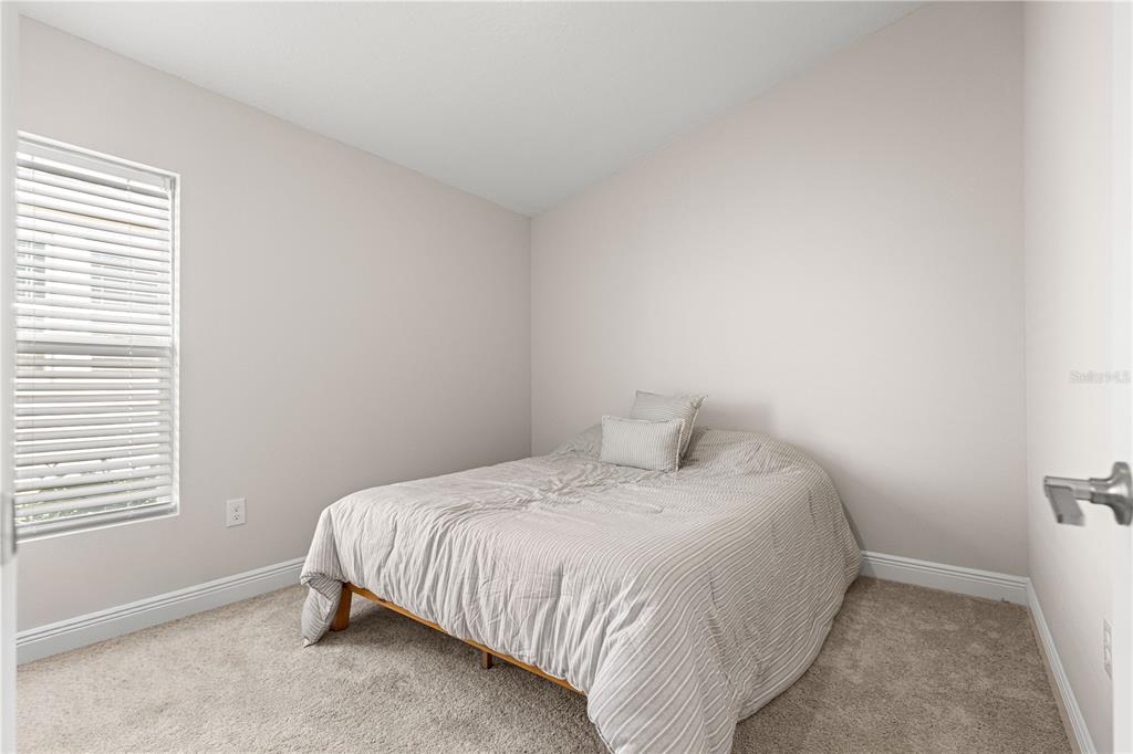 9611 Southwest 62nd Court Ocala, FL 34476 - Photo 16 of 41 a bedroom with a bed and a window