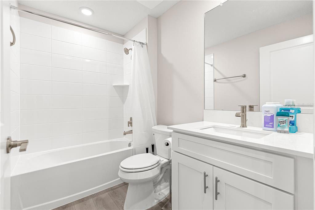 9611 Southwest 62nd Court Ocala, FL 34476 - Photo 17 of 41 a bathroom with a sink a toilet and shower