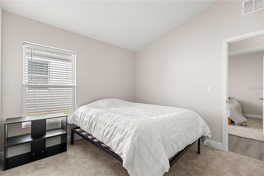 9611 Southwest 62nd Court Ocala, FL 34476 - Photo 24 of 41 a bedroom with a bed and a window