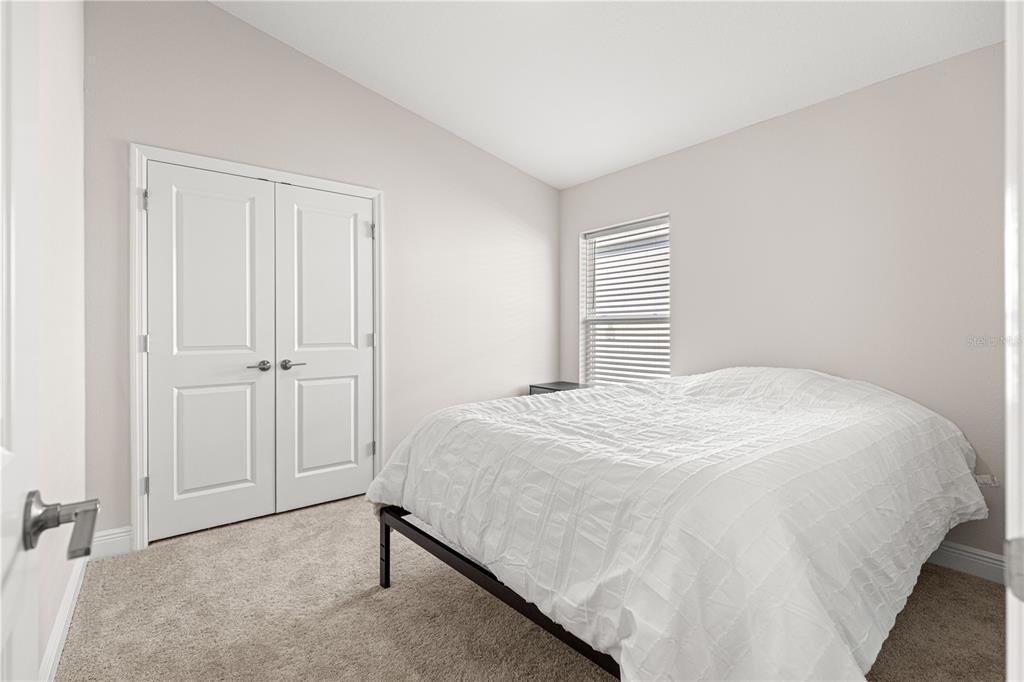 9611 Southwest 62nd Court Ocala, FL 34476 - Photo 25 of 41 a bedroom with a bed and a closet