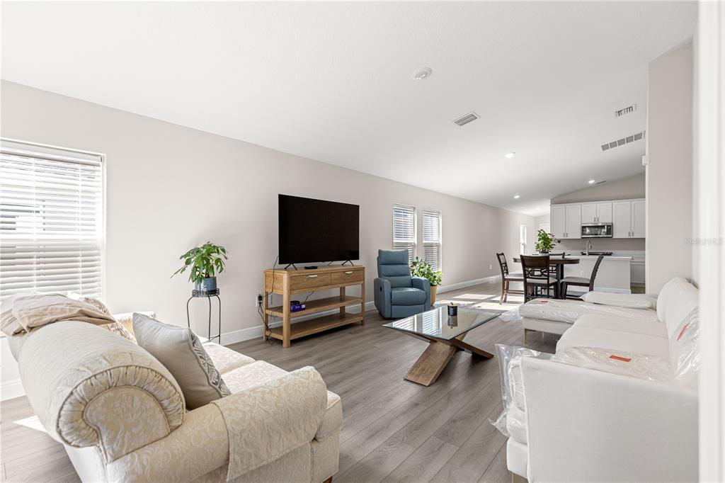 9611 Southwest 62nd Court Ocala, FL 34476 - Photo 3 of 41 a living room with furniture and a flat screen tv