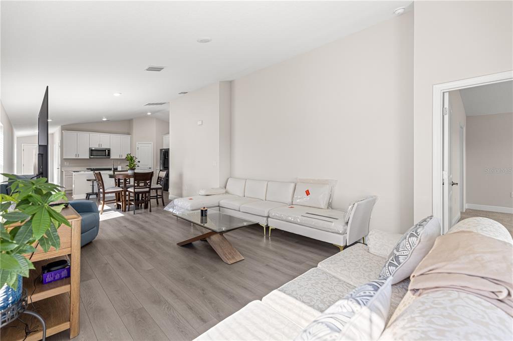9611 Southwest 62nd Court Ocala, FL 34476 - Photo 4 of 41 a living room with furniture and wooden floor