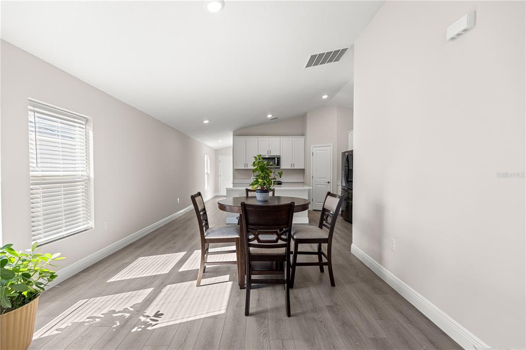 9611 Southwest 62nd Court Ocala, FL 34476 - Photo 5 of 41 a view of a dining room with furniture and wooden floor