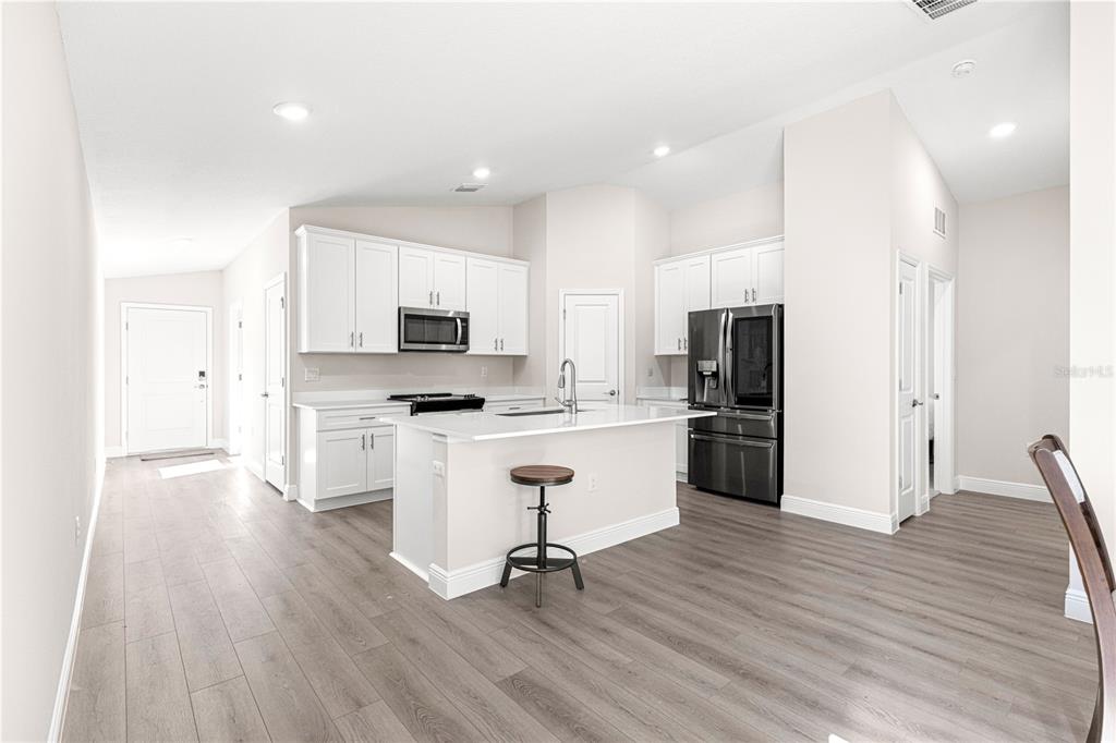 9611 Southwest 62nd Court Ocala, FL 34476 - Photo 8 of 41 a kitchen with white cabinets and stainless steel appliances