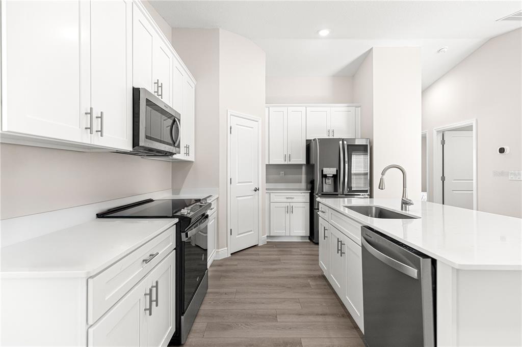 9611 Southwest 62nd Court Ocala, FL 34476 - Photo 9 of 41 a kitchen with stainless steel appliances granite countertop a white cabinets a sink a stove and a refrigerator