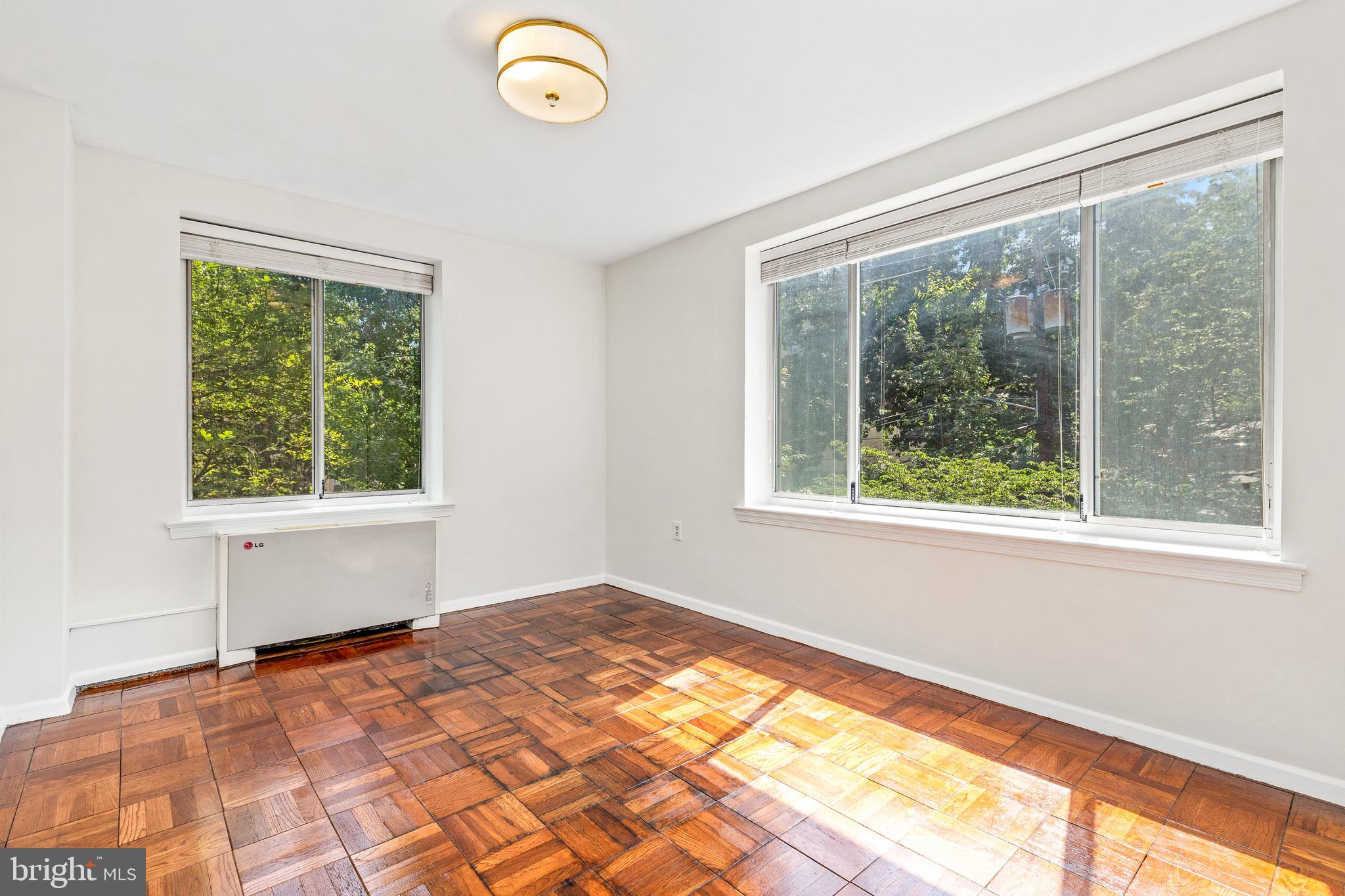 4100 W Street Northwest, Unit 306 Washington, DC 20007 - Photo 14 of 23 a view of an empty room with wooden floor and a window