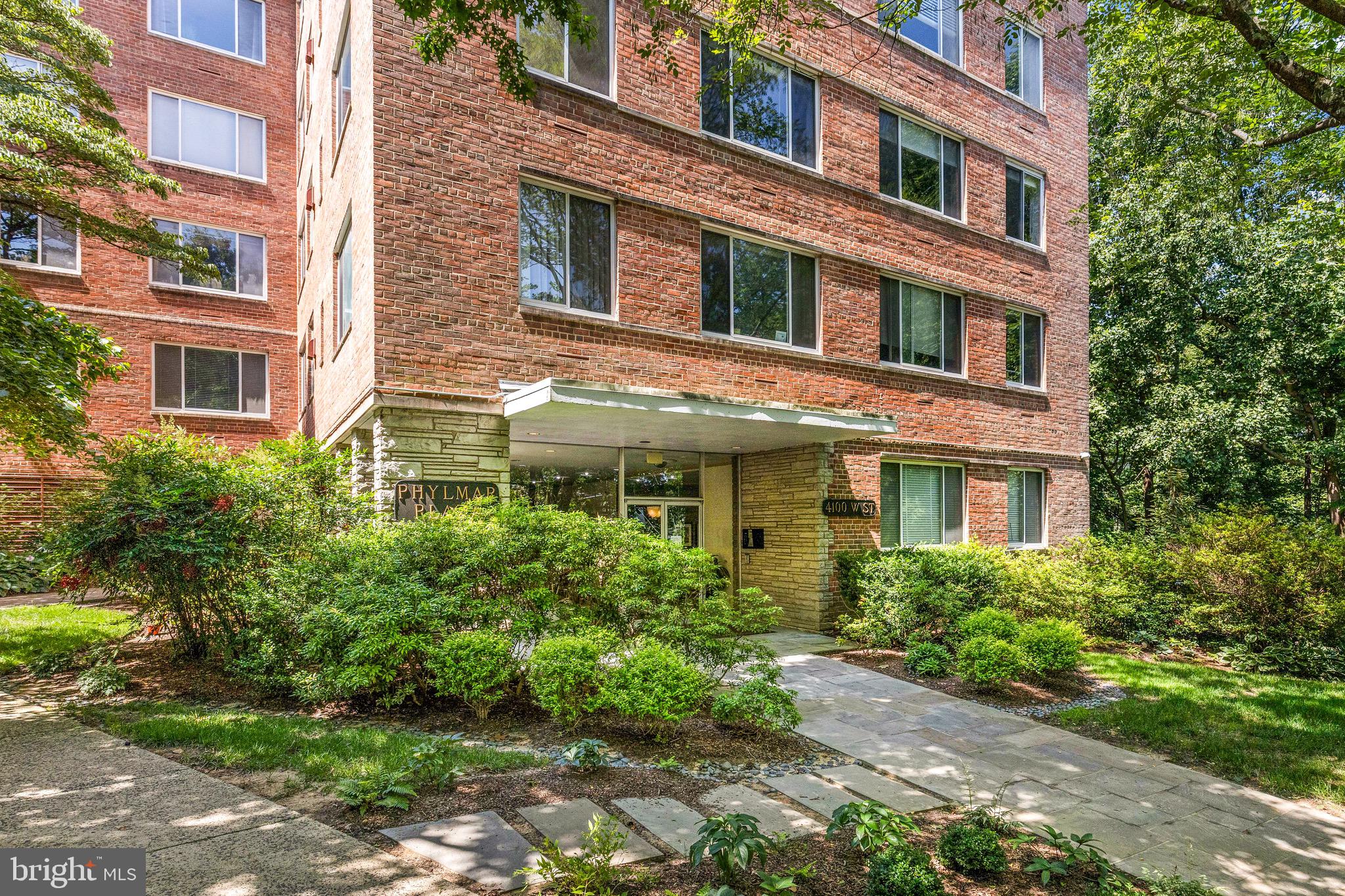 4100 W Street Northwest, Unit 306 Washington, DC 20007 - Photo 17 of 23 a yellow building with potted plants in front of it