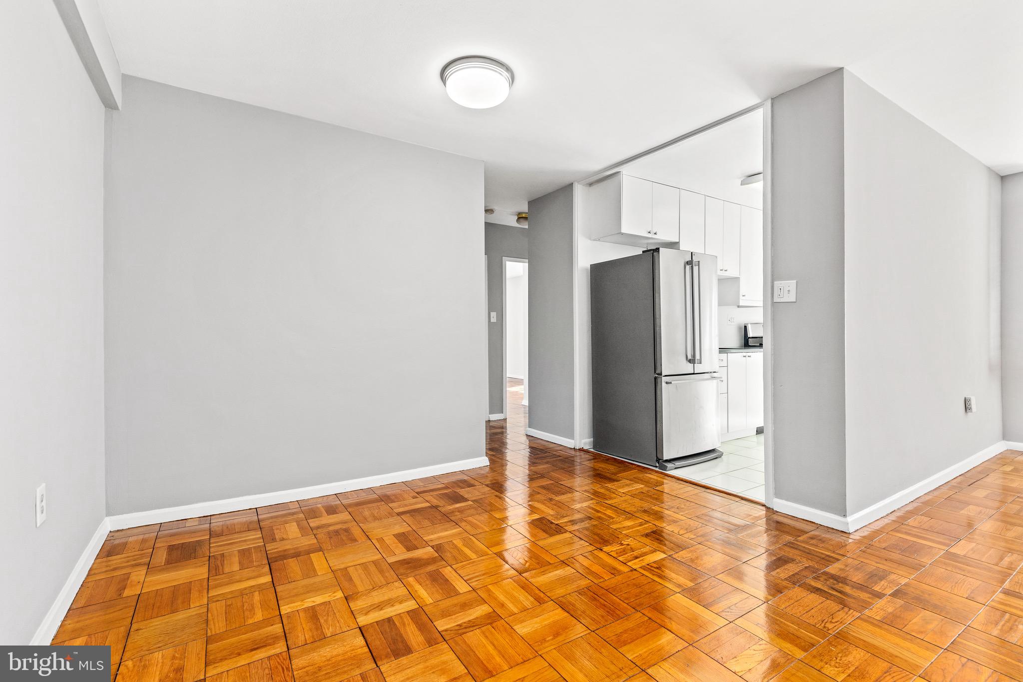 4100 W Street Northwest, Unit 306 Washington, DC 20007 - Photo 6 of 23 a view of a livingroom with wooden floor and a refrigerator