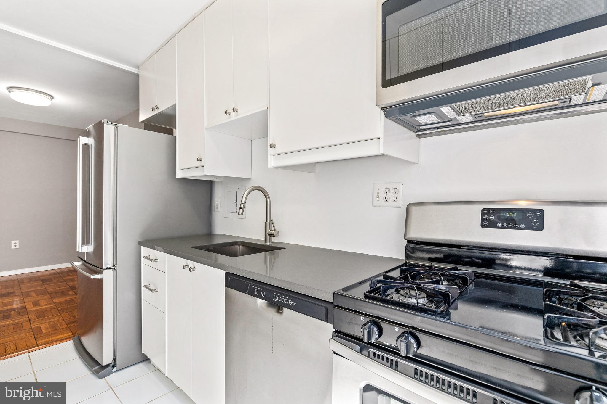 4100 W Street Northwest, Unit 306 Washington, DC 20007 - Photo 9 of 23 a kitchen with a stove and a refrigerator