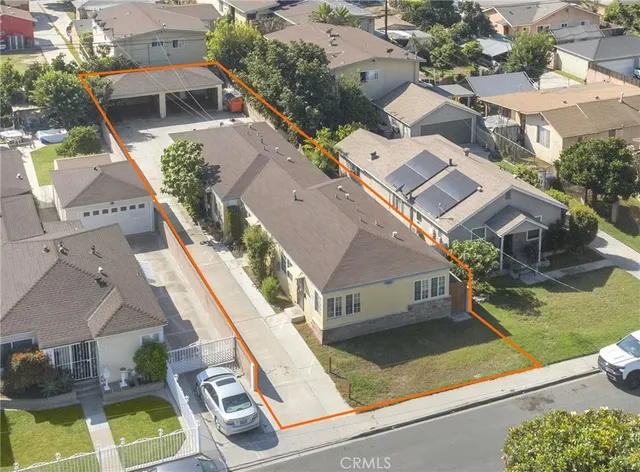 an aerial view of residential houses with yard
