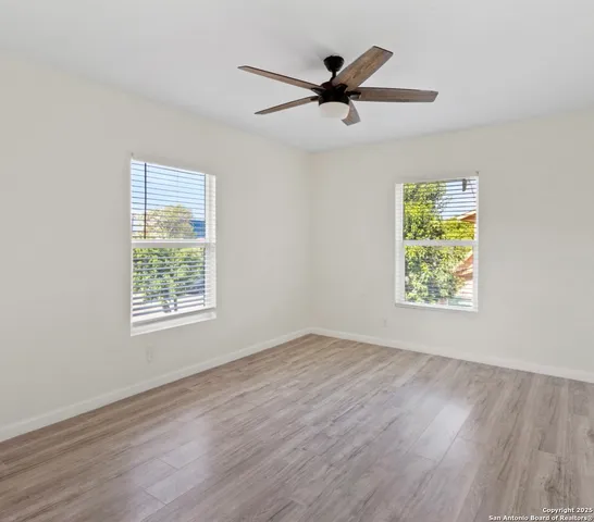 a view of room with hardwood floor and window