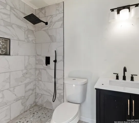 a bathroom with a toilet and a shower