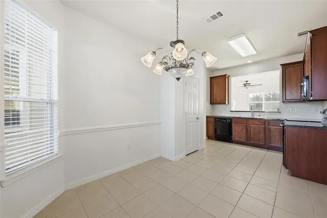 a view of a kitchen with a sink and dishwasher