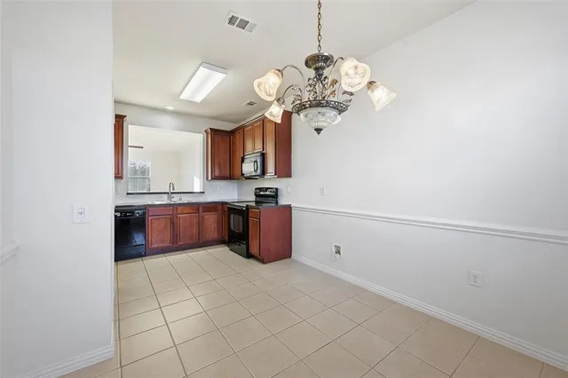 a view of kitchen with a sink and chandelier