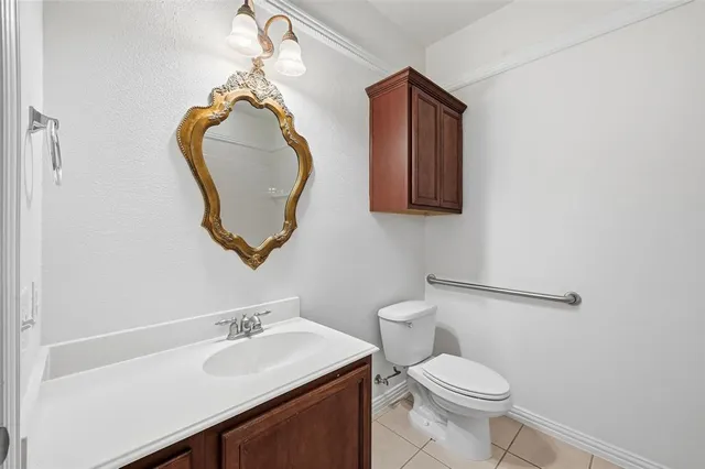 a bathroom with a toilet sink vanity and mirror