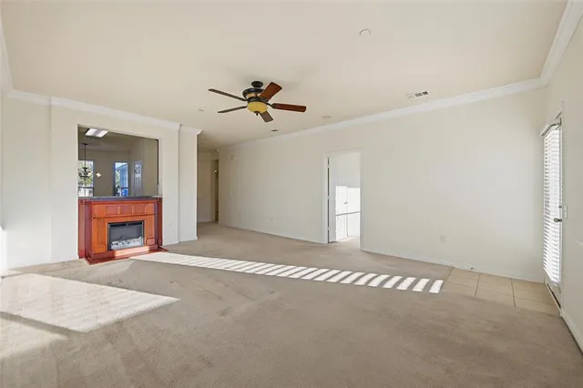a view of a livingroom with a fireplace and a window