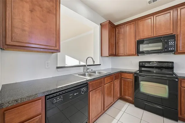a kitchen with stainless steel appliances granite countertop a sink stove and microwave