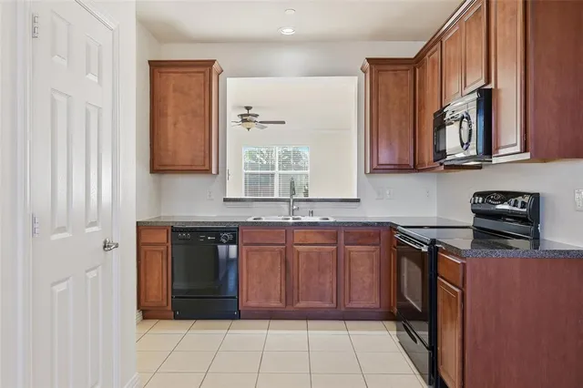 a kitchen with stainless steel appliances granite countertop a refrigerator and a stove
