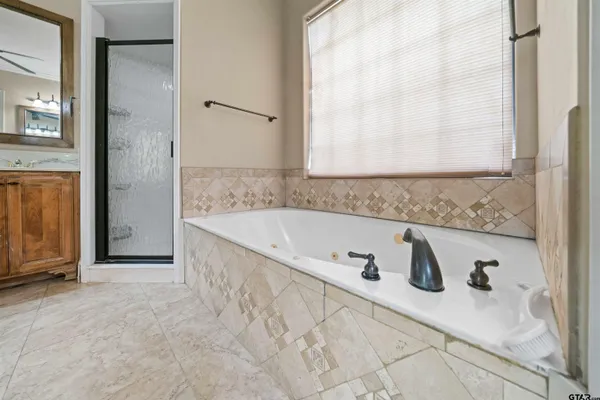 a spacious bathroom with a tub and a shower