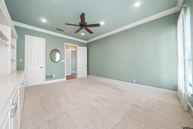 a view of a livingroom with a ceiling fan and window