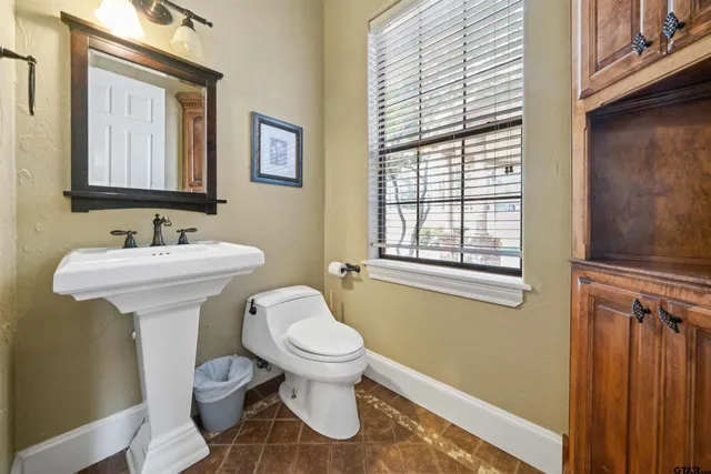 a bathroom with a sink toilet and a mirror