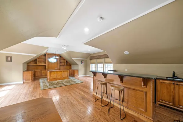 a view of a room with lots of wooden furniture