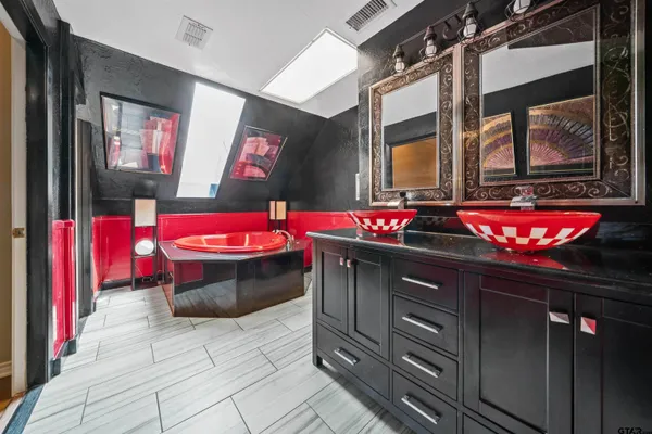 a kitchen with stainless steel appliances granite countertop a sink and wooden cabinets