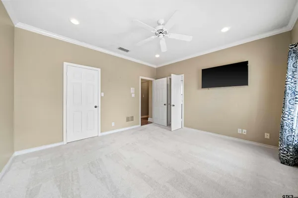 an empty room with fan and windows