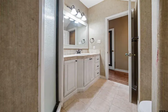 a bathroom with a double vanity sink and a mirror