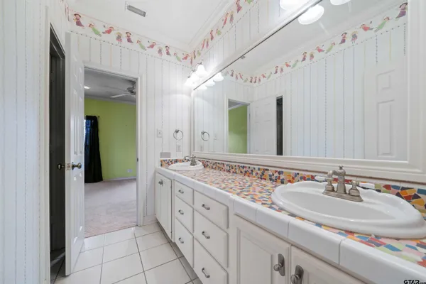 a bathroom with a double vanity sink and a mirror