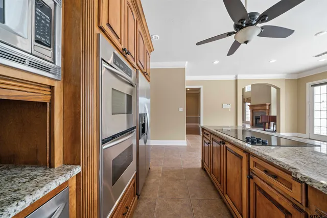 a kitchen with granite countertop a sink and stainless steel appliances