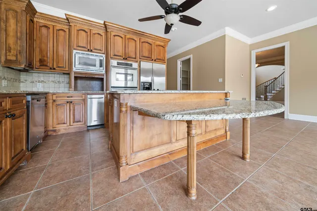 a kitchen with stainless steel appliances granite countertop a stove a sink and a granite counter tops
