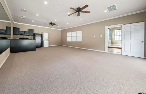 a view of a livingroom with a ceiling fan a ceiling fan and windows