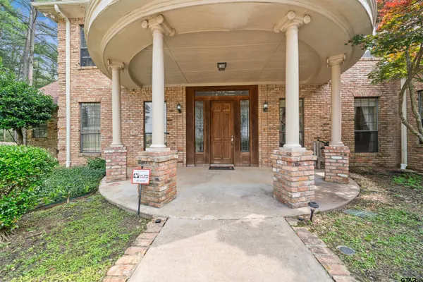 a front view of a house with outdoor seating