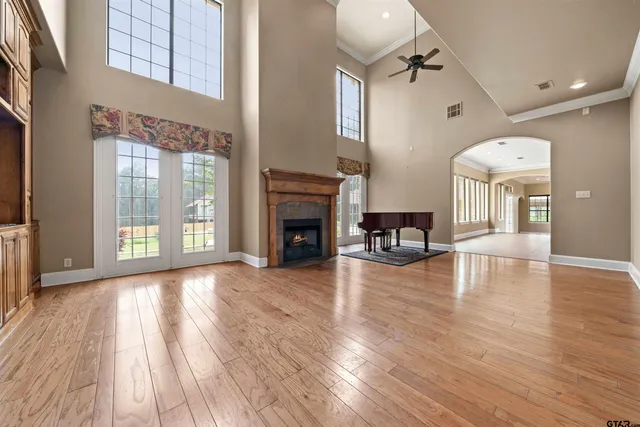 a view of a livingroom with furniture a fireplace and wooden floor