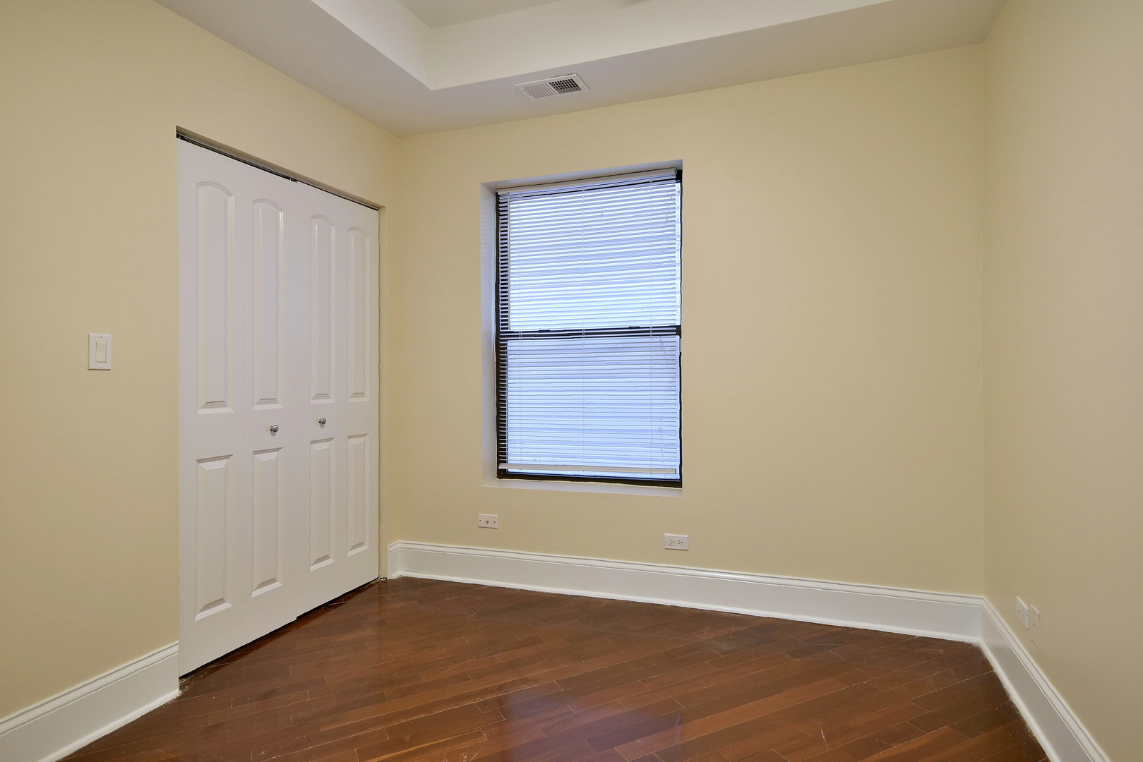 4819 South Prairie Avenue, Unit 1 Chicago, IL 60615 - Photo 12 of 16 a view of an empty room with wooden floor and a window