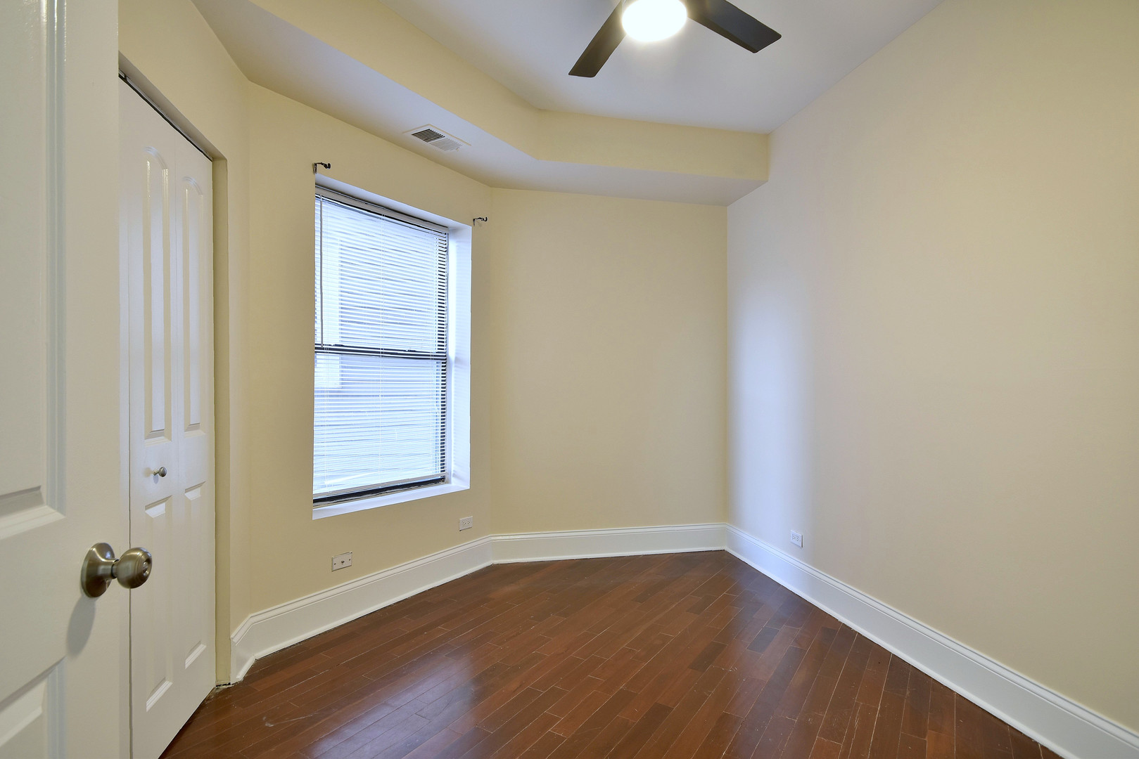 4819 South Prairie Avenue, Unit 1 Chicago, IL 60615 - Photo 13 of 16 an empty room with a window and wooden floor