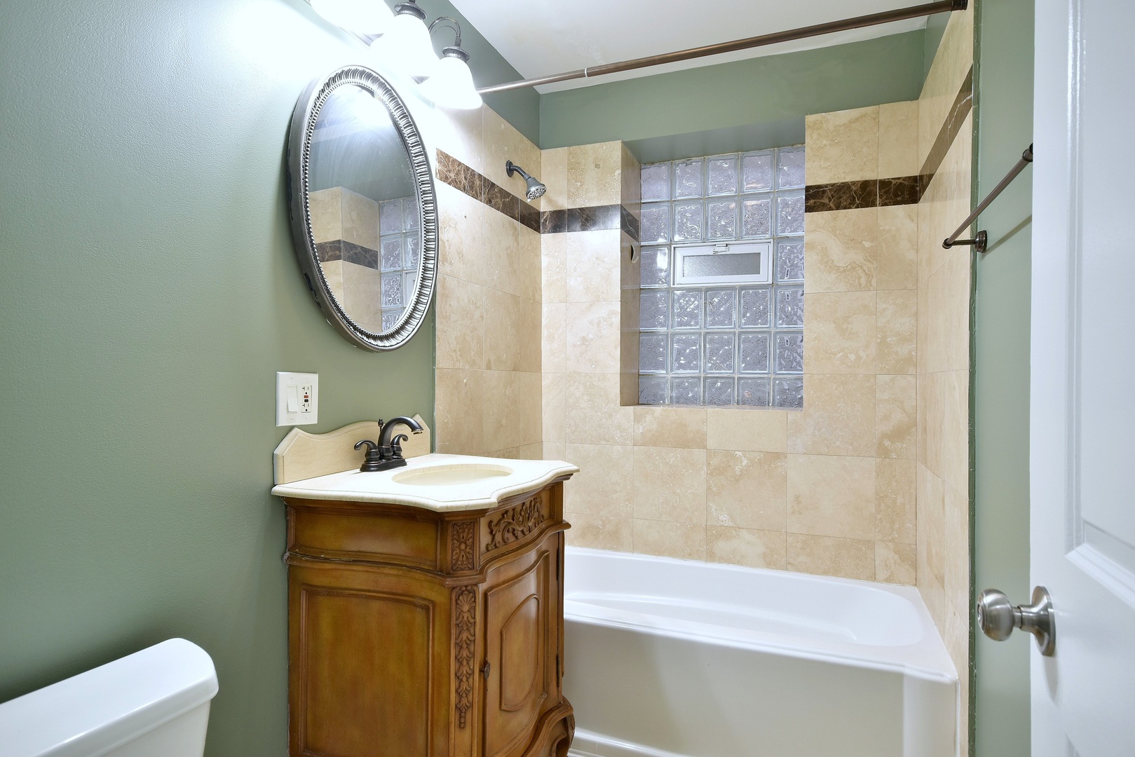4819 South Prairie Avenue, Unit 1 Chicago, IL 60615 - Photo 14 of 16 a bathroom with a sink a toilet and a mirror