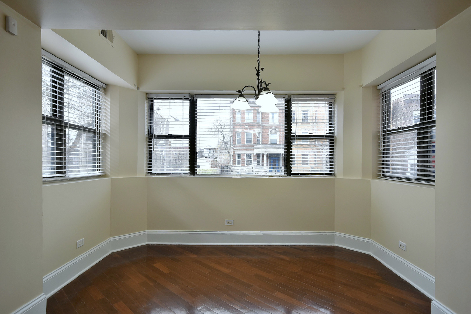 4819 South Prairie Avenue, Unit 1 Chicago, IL 60615 - Photo 6 of 16 a view of an empty room with wooden floor and a window