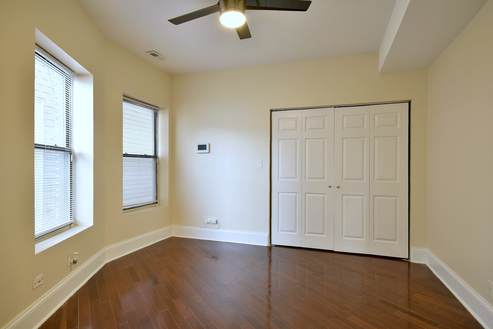 4819 South Prairie Avenue, Unit 1 Chicago, IL 60615 - Photo 7 of 16 a view of an empty room with wooden floor and a window