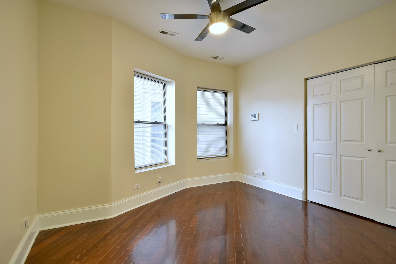 4819 South Prairie Avenue, Unit 1 Chicago, IL 60615 - Photo 8 of 16 a view of an empty room with wooden floor and a window